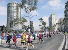  ?? PHOTOS BY PHOTO BY TRACY ROMAN ?? Runners take part in a previous Long Beach Marathon. The 26.2-mile race will return Sunday for the first time since 2019.