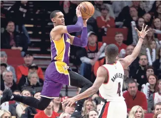  ??  ?? Los Angeles Lakers guard Jordan Clarkson (left) passes the ball away from Portland Trail Blazers forward Maurice Harkless during the second half of an NBA basketball game in Portland, Oregon on Thursday. The Trail Blazers won 118-109.