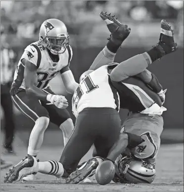  ?? JASON E. MICZEK/AP PHOTO ?? Carolina’s Cam Newton, right, fumbles the ball as he lands on his head after being hit by New England’s Deatrich Wise (91) during the first half of Friday’s NFL preseason game in Charlotte, N.C. The Panthers recovered the ball.