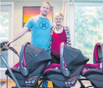  ??  ?? Mahalia Meeuwsen and husband Mike show off their new stroller, nicknamed the “train,” for their expected identical triplet girls. The babies are scheduled to be born by C-section on Nov. 16.