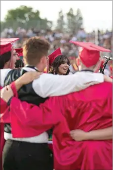  ?? ELIZA GREEN / THE CALIFORNIA­N ?? Members of the North High School choir huddle together as they perform the North High alma mater at the start of the June 2 graduation ceremony.