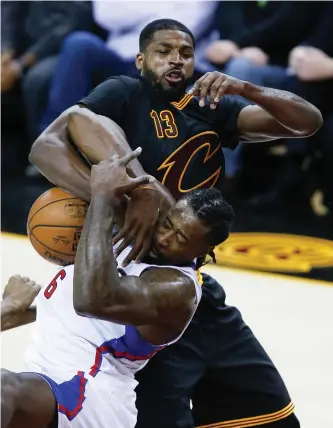  ?? Associated Press ?? Cleveland’s Tristan Thompson (13) battles LA’s DeAndre Jordan (6) for a rebound Thursday in Cleveland.