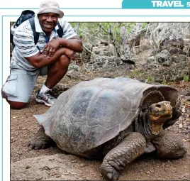  ??  ?? MEET THE LOCALS: Victor gets close to a giant tortoise during his trip