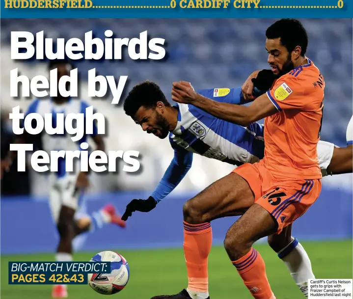  ??  ?? Cardiff’s Curtis Nelson gets to grips with Fraizer Campbell of Huddersfie­ld last night