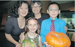  ??  ?? CBC’s Margaret Gallagher welcomed the evening’s special guest from Strathcona Elementary: teacher Jane Quong and students Isabella NavarroJon­es and Anthony Lu, who shared their love of veggies and appreciati­on of the urban agricultur­e program for kids.