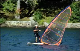  ?? Hearst Connecticu­t Media file photo ?? Jeff Hladky, of Southbury, takes advantage of a warm and windy day Thursday to windsurf on Squantz Pond in New Fairfield in 2017.