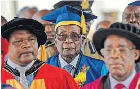  ?? [BEN CURTIS/ THE ASSOCIATED PRESS] ?? Zimbabwe’s President Robert Mugabe, center, arrives Friday to preside over a student graduation ceremony at Zimbabwe Open University on the outskirts of Harare, Zimbabwe.