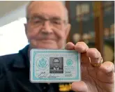  ?? AP ?? Paul Grisham with his old US Navy identity card, from a wallet he lost during a posting at McMurdo Station in the 1960s.