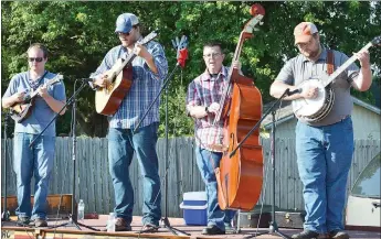  ?? TIMES photograph by Annette Beard ?? Adam Ash, far right, former manager of Webb Feed and Seed, plays banjo with fellow band members in the Spillwater Drive band, from left, Sam Cobb, Jake Stogdill and Gary Cook.