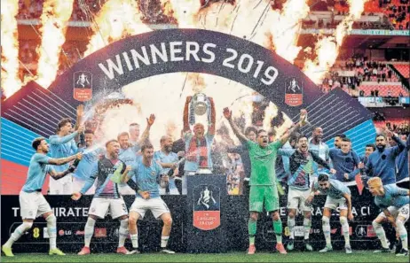  ?? AFP ?? Manchester City players celebrate after beating Watford 6-0 to lift the FA Cup at the Wembley Stadium in London on Saturday.