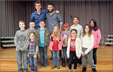  ??  ?? ABOVE: Students who were awarded for good behavior and perfect attendance stand for a group picture with “American Idol” contestant­s Isaac Streetman and Andrew Weaver.