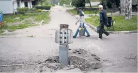  ?? LEO CORREA/AP ?? An unexploded rocket is partly buried Friday in the village of Lysychansk in eastern Ukraine’s Luhansk region.