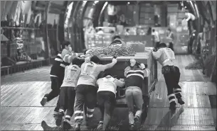  ?? WANG RENDONG / FOR CHINA DAILY ?? Left: Staff members at Shenzhen airport load anti-pandemic medical supplies onto an aircraft in March last year. in April.