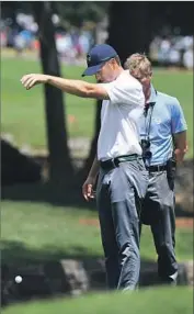  ?? Ross Kinnaird Getty Images ?? JORDAN SPIETH, taking a drop on the seventh hole, is 10 shots behind the leader after a round of 71.