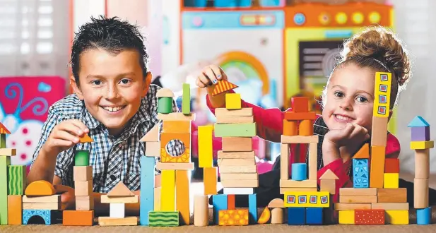  ?? Picture: TIM CARRAFA ?? SAFE FUN: Manny, 9, and Mia, 6, play with wooden toys which may be safer than plastic.