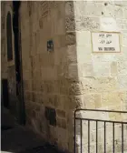  ??  ?? ■ A sign marks the Via Dolorosa—also known as the Way of Grief, the Way of Sorrow and the Way of Suffering—on a street pathway Christ took through Old Jerusalem to his crucifixio­n site now known as Skull Hill.