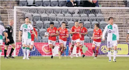  ?? Photo / Getty Images ?? The Phoenix celebrate Ulises Davila’s penalty equaliser just before the break.