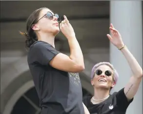  ?? Seth Wenig / Associated Press ?? The U.S. women’s soccer team captains Alex Morgan, left, and Megan Rapinoe celebrate at City Hall after a ticker tape parade on Wednesday in New York.