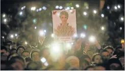  ??  ?? MARKING THE ORANGE: A crowd at Independen­ce Square in Kiev, Ukraine, with posters of former Prime Minister Yulia Tymoshenko who led the 2004 Orange Revolution