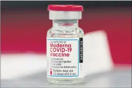  ?? DAVID ZALUBOWSKI — THE ASSOCIATED PRESS FILE ?? A vial of the Moderna COVID-19 vaccine at a hospital in Denver.