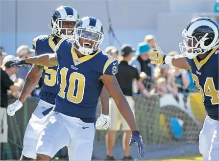  ?? Photograph­s by Phelan M. Ebenhack Associated Press ?? PHAROH COOPER (10) of the Rams enjoys the moment after returning the opening kickoff 103 yards for a score against the Jaguars.