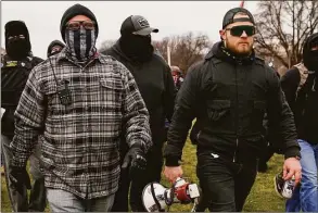  ?? Carolyn Kaster / Associated Press file photo ?? Proud Boys members Joseph Biggs, left, and Ethan Nordean, right with megaphone, walk toward the U.S. Capitol in Washington on Jan. 6, 2021.