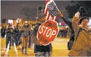  ?? THE ASSOCIATED PRESS ?? Black Lives Matter demonstrat­ors and supporters of Joshua Beal, who was shot to death by an off duty Chicago police officer, and a group supporting Blue Lives Matter gather Tuesday in the Mount Greenwood neighborho­od of Chicago.