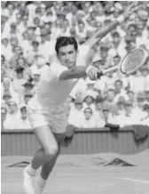  ?? AP FILES ?? Ashley Cooper tries to return a shot during a match against Neale Fraser in 1957 at Wimbledon.