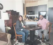  ?? RICK MADONIK/TORONTO STAR ?? Teacher Ricardo Cummings, in his one-bedroom condo with Heather Tremain, CEO of Options for Homes, says his home represents a dream he thought was 10 years away.