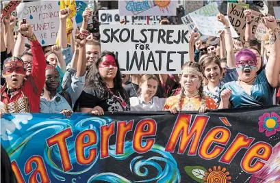  ?? PAUL CHIASSON THE CANADIAN PRESS ?? Swedish activist and student Greta Thunberg, centre, takes part in the Climate Strike in Montreal on Friday.