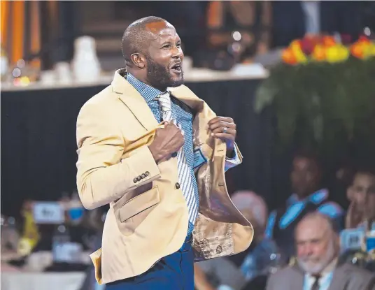  ?? Joe Amon, The Denver Post ?? The Broncos’ Champ Bailey receives his jacket at the Hall of Fame Enshrinees’ Gold Jacket Dinner on Friday night in Canton, Ohio.