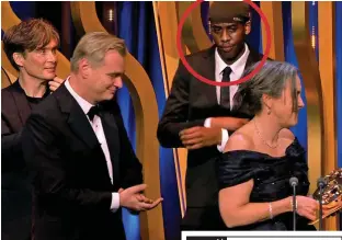  ?? ?? Photo-bomb: Cillian Murphy spots Lizwani, circled, as Christophe­r Nolan and wife Emma Thomas accept the Bafta for Best Picture