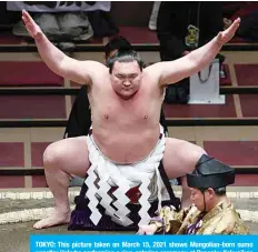  ?? —AFP ?? TOKYO: This picture taken on March 15, 2021 shows Mongolian-born sumo wrestler Hakuho performing a ring-entering ceremony at Ryogoku Kokugikan in Tokyo.