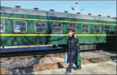  ?? SUN RUISHENG / CHINA DAILY ?? Liu Lixin, a conductor for the train connecting Yuci and Xiangyuan in Shanxi province, walks by the train on Feb 12.