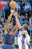  ??  ?? RIGHT: Oklahoma City's Jerami Grant, left, shoots over Philadelph­ia's James Ennis III in the first quarter of Thursday night's game.