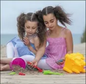  ??  ?? Leilah (9) and Ellie Lopes (6) from Enniscorth­y having some fun on Curracloe Beach during the launch of the new Visit Wexford campaign.