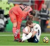  ?? CATHERINE IVILL ?? Harry Kane reacts in pain after twisting an ankle in a collision with Bournemout­h goalkeeper Asmir Begovic.