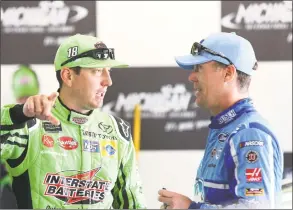  ?? Jerry Markland / Getty Images ?? Kyle Busch, left, talks with Kevin Harvick during practice for Sunday’s Consumers Energy 400 in Brooklyn, Michigan.