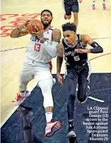  ??  ?? LA Clippers guard Paul George (13) drives to the basket against San Antonio Spurs guard Dejounte Murray (5)