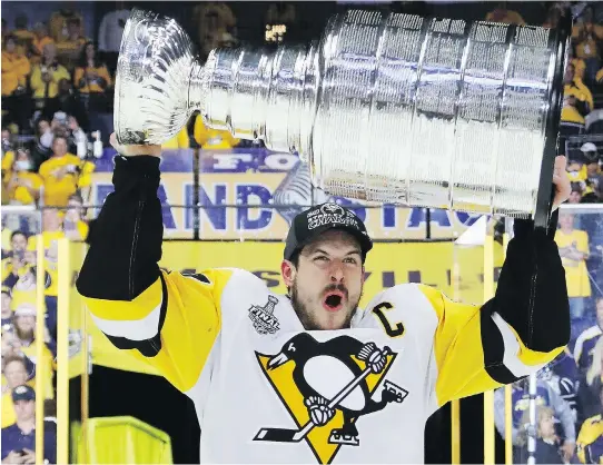  ?? BRUCE BENNETT/GETTY IMAGES ?? Penguins captain Sidney Crosby celebrates with the Stanley Cup after his team defeated the Predators 2-0 on Sunday in Nashville, Tenn.