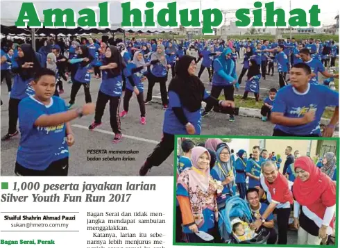  ??  ?? PESERTA memanaskan badan sebelum larian.
PASANGAN suami isteri bersama anak kecil berjaya menamatkan larian.