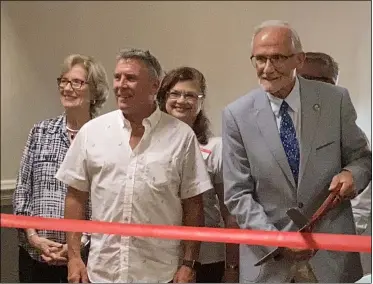  ?? KEVIN MARTIN — THE MORNING JOURNAL ?? Avon Lake Mayor Greg Zilka, right, and Joe Matuscak, director of marketing and developmen­t for The LCADA Way, partakes in a ceremonial ribbon-cutting welcoming guests to the North Coast Business Expo on July 15at Ahern’s Banquet Center, 726 Avon Belden Road.