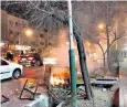  ??  ?? Bags of rubbish set alight by demonstrat­ors in the streets of a north Tehran suburb