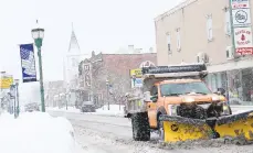  ?? AMY SHORTELL/THE MORNING CALL ?? A Northampto­n Department of Public Works plow clears Main Street in the borough.