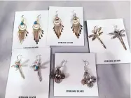  ?? ROSALIE RAYBURN/FOR THE JOURNAL ?? A selection of Navajo-made silver earrings for sale at Rio Grande Trading, ranging in price from $19.80 to $49.80. Retail manager Annie Johnson said dragonfly shapes are currently very popular.