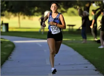  ?? PHOTOS: KEITH BIRMINGHAM — STAFF PHOTOGRAPH­ER ?? Nadia Mejia of Millikan won the girls 3-mile run with a time of 17:26during the first Moore League meet of the season.