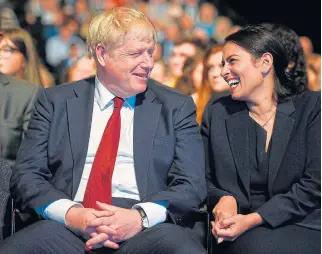  ?? /AFP ?? What a hoot: UK Prime Minister Boris Johnson with home secretary Priti Patel at the Conservati­ve Party conference in Manchester.
