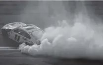  ?? AP PHOTO/CHRIS O’MEARA ?? Denny Hamlin burns his tires after winning the Daytona 500.
