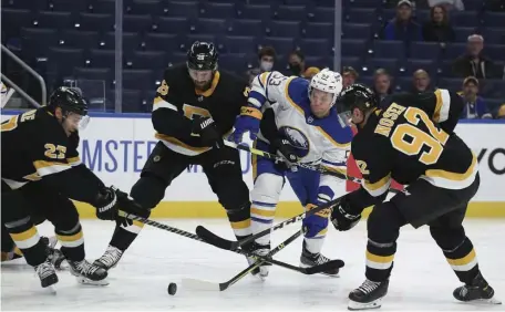  ?? Ap; BELOw, Ap fiLE ?? BACK IN ACTION : Buffalo Sabres left wing Jeff Skinner (53) tries to shoot while defended by Bruins blueliner John Moore (27), defenseman Derek Forbort (28) and left wing Tomas Nosek (92) during the first period on Friday night in Buffalo, N.Y. Below, Bruins forward Anton Blidh, right, fends off Vegas Golden Knights defenseman Deryk Engelland on Jan. 21, 2020.