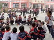  ??  ?? Students play a game during their lunch break at the Zhongxin Primary School in Tokkuzak township, Shufu county in the Xinjiang Uygur autonomous region.